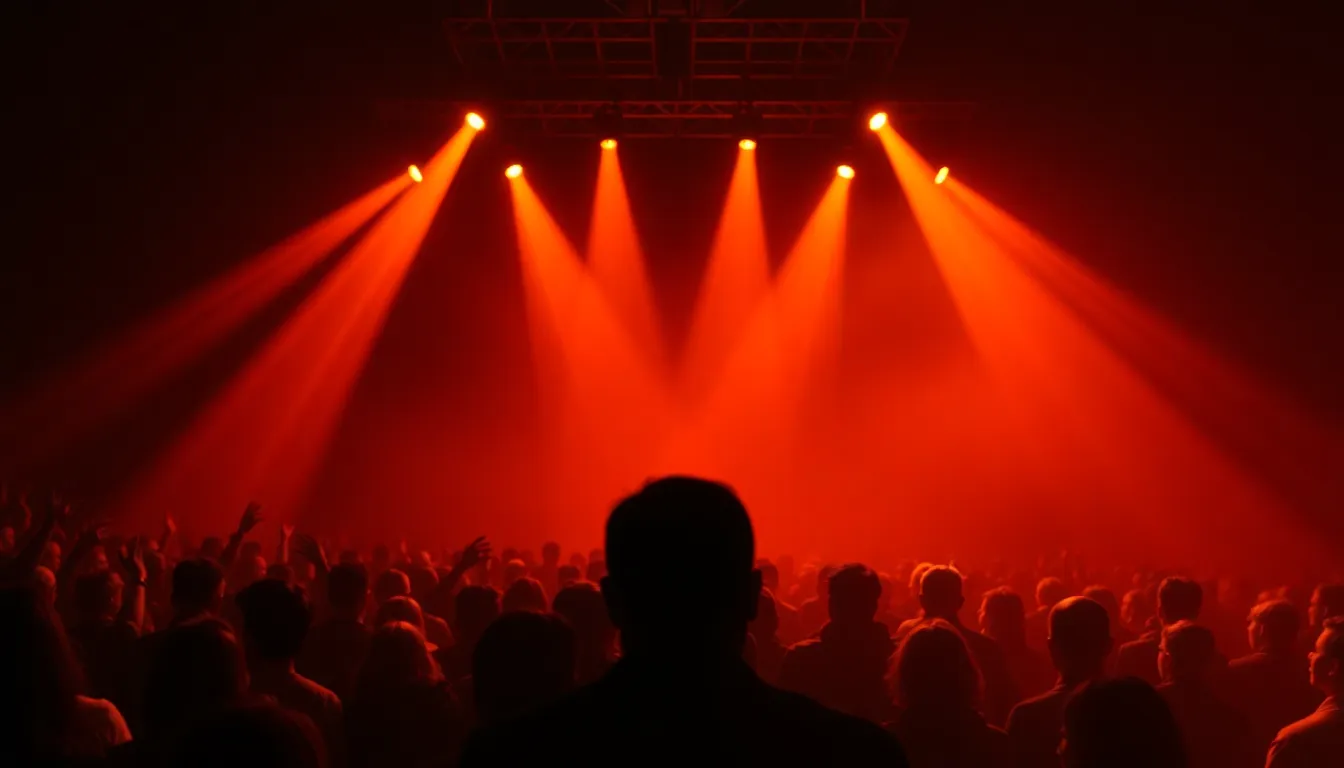 Crowd viewed from behind silhouetted against intense amber and sodium light beams cutting through stadium haze during a physical live theater spectacle